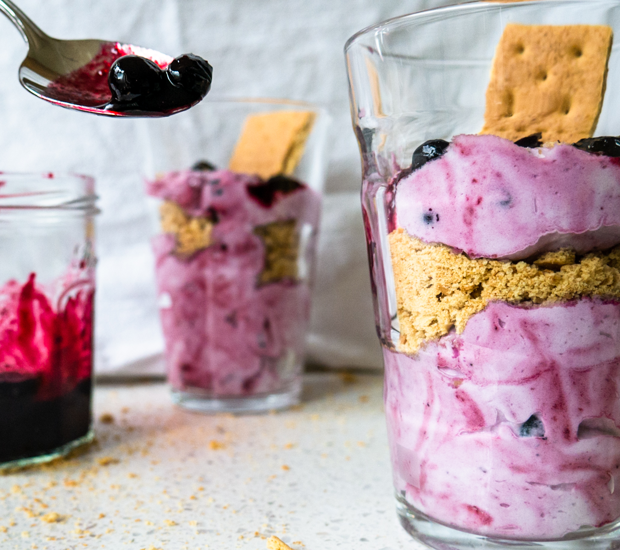 blueberry fool with spoon of blueberry sauce