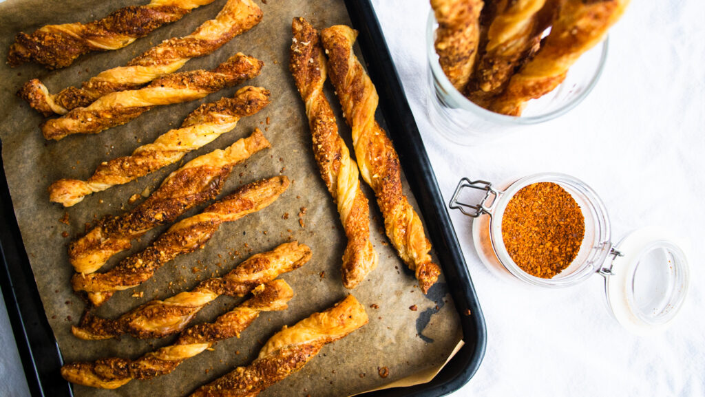 cheese twists from above with cayenne and cup of cheese twists