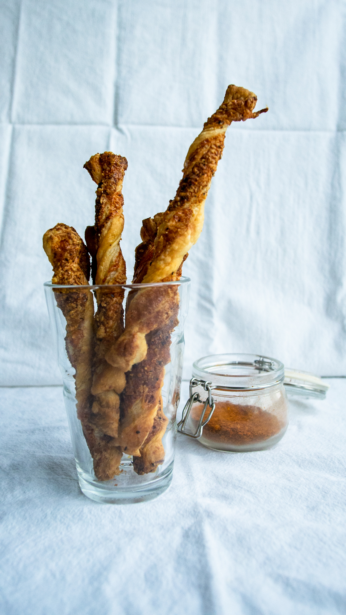 cheese twists in a cup with cayenne