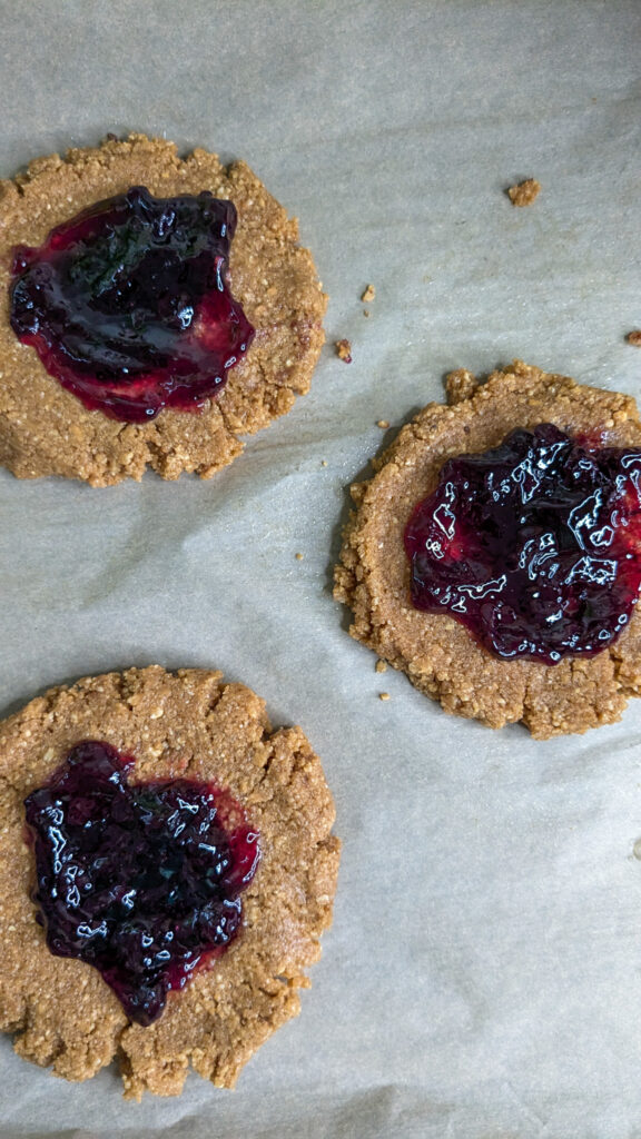 peanut butter sandies with blueberry jam on top