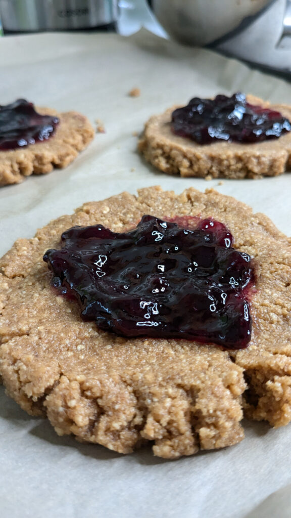 uncooked peanut butter cookie with blueberry jam