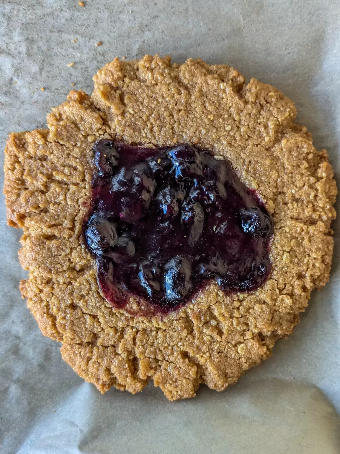 peanut butter sandies with blueberry jam on top