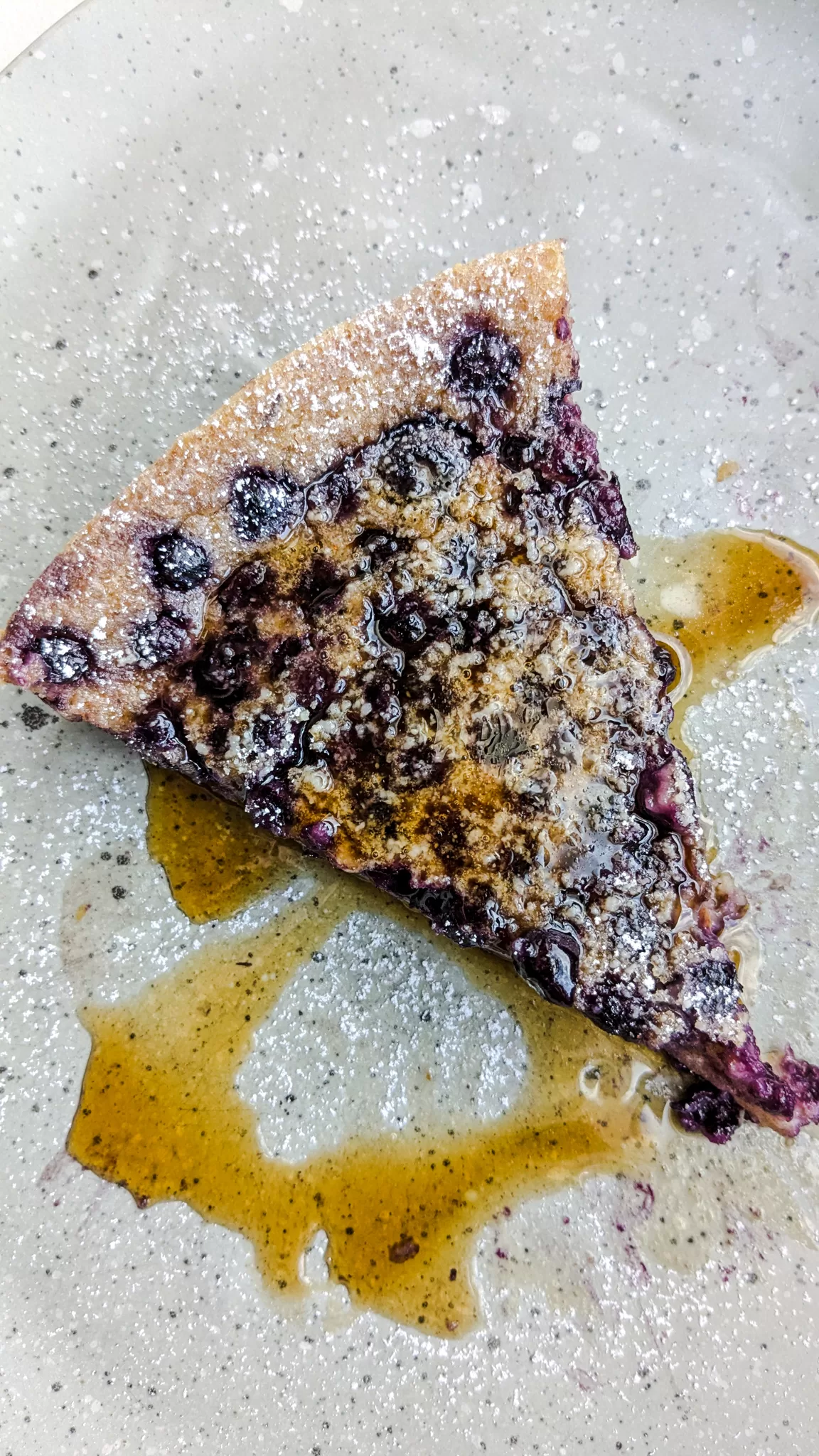 sourdough discard clafoutis with blueberries and powdered sugar on top